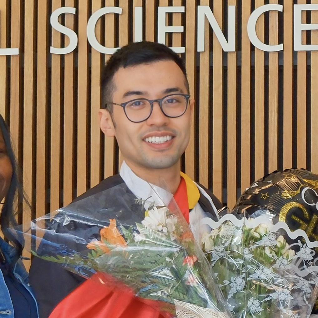 Zung-Ru Lin holding a bouquet at a graduation celebration